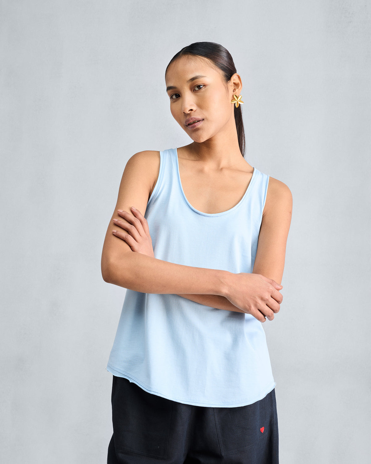 Person wearing a light blue sleeveless racerback tank.