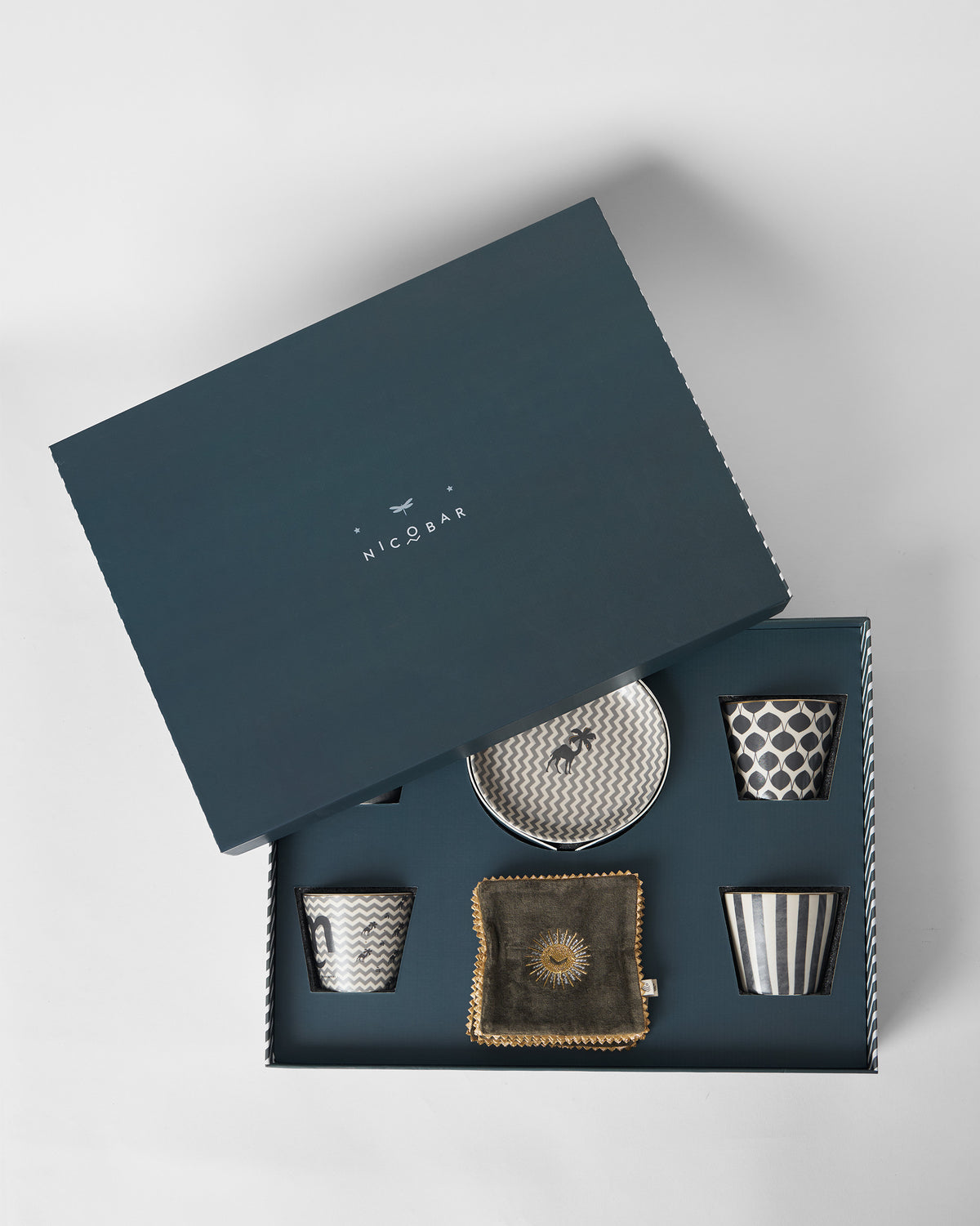Twilight gift box with the lid propped open to show cups, plate and coaster.