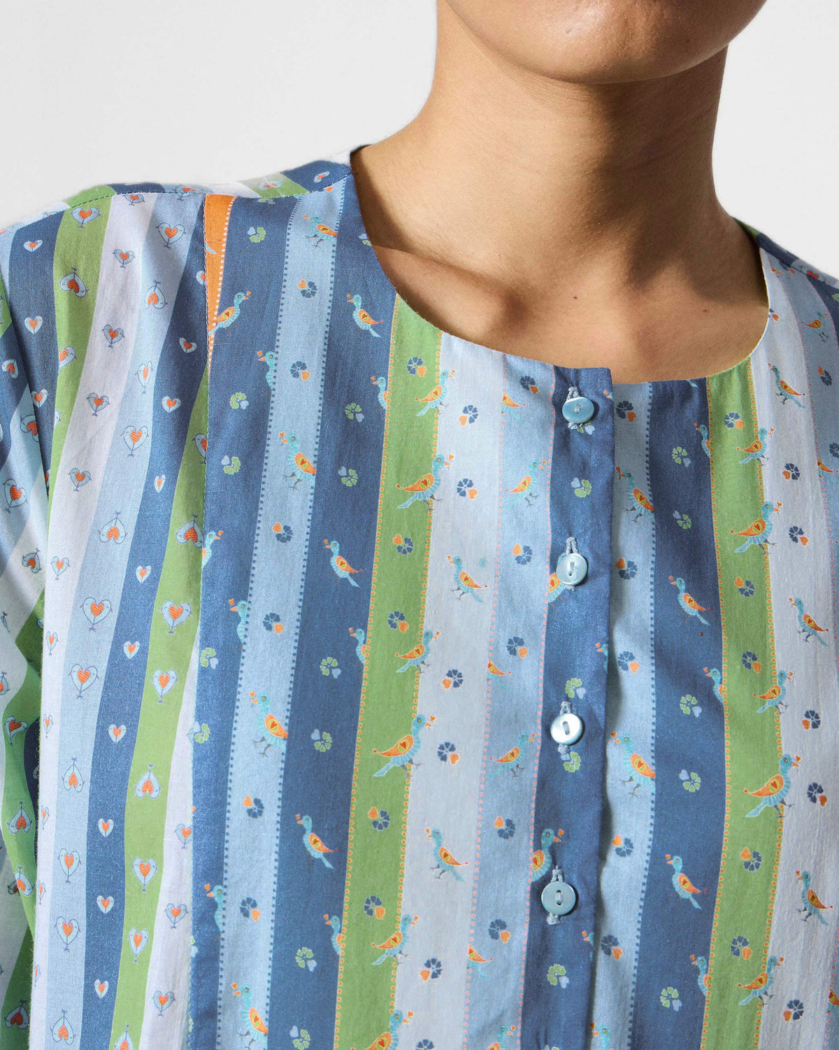 Close-up of the Imke kurta's bird-print stripes and button placket.