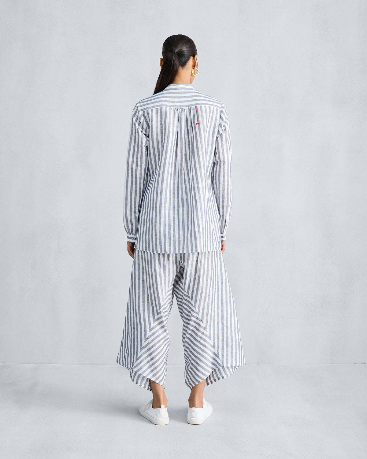 Back of the Mandarin Collar shirt worn by a person, in charcoal and white stripes with a gathered yoke.