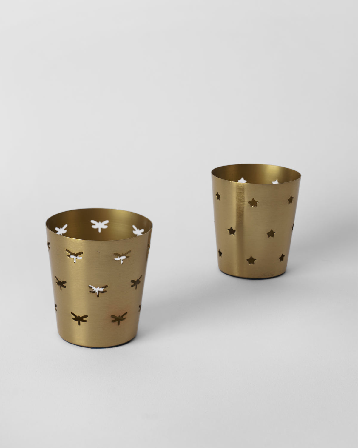 Smriti gold votives showing dragonfly and star cutout patterns.