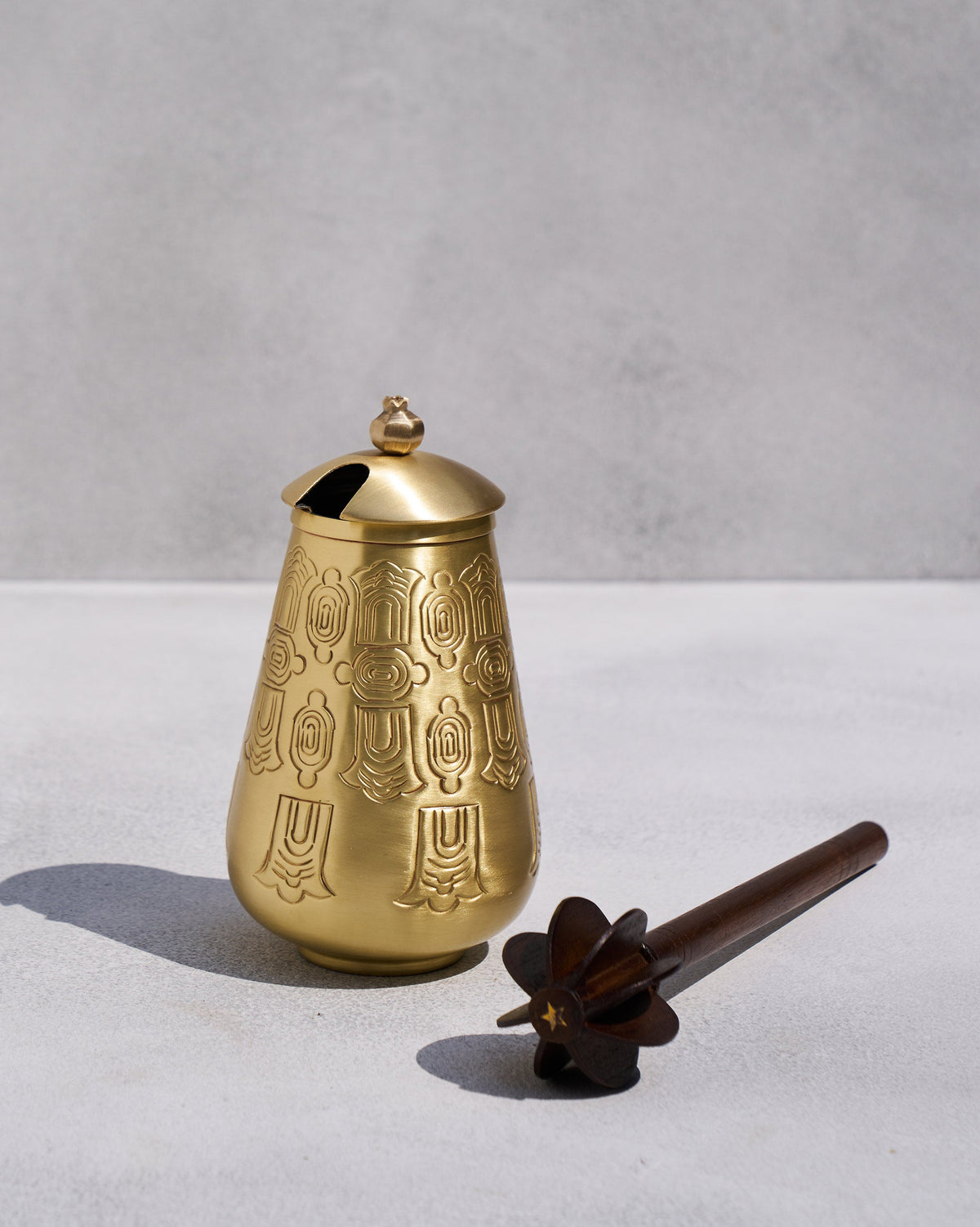 Heritage Churn Set brass vessel beside a dark wooden churner.