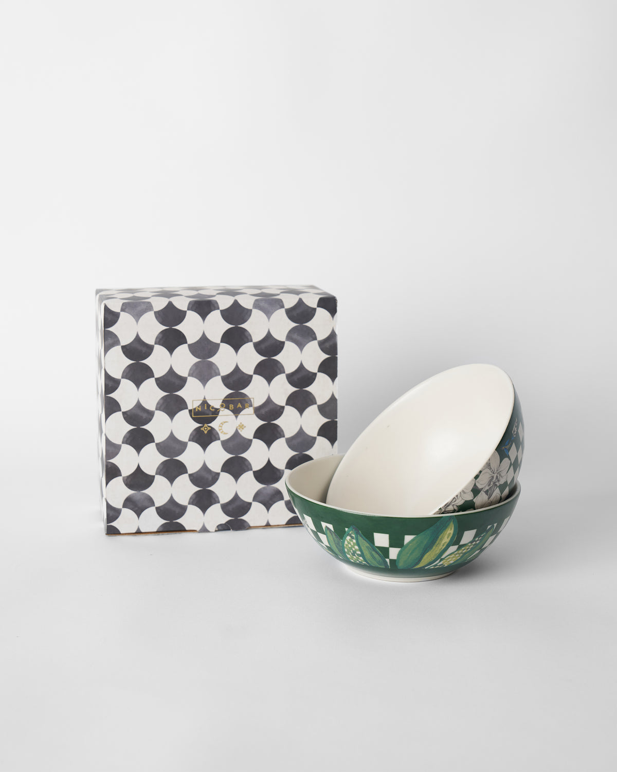 Reesha vegetable bowls nested in front of a patterned Nicobar gift box.