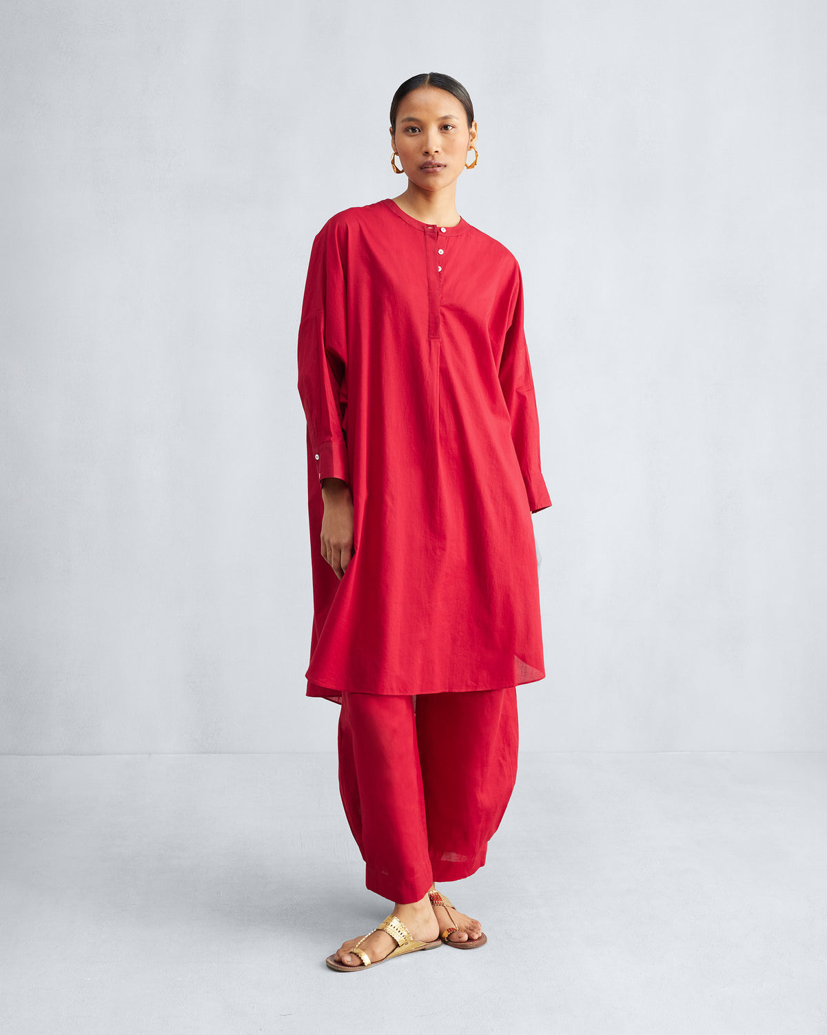 Person wearing a red Lazy Sunday tunic set with wide-leg pants.