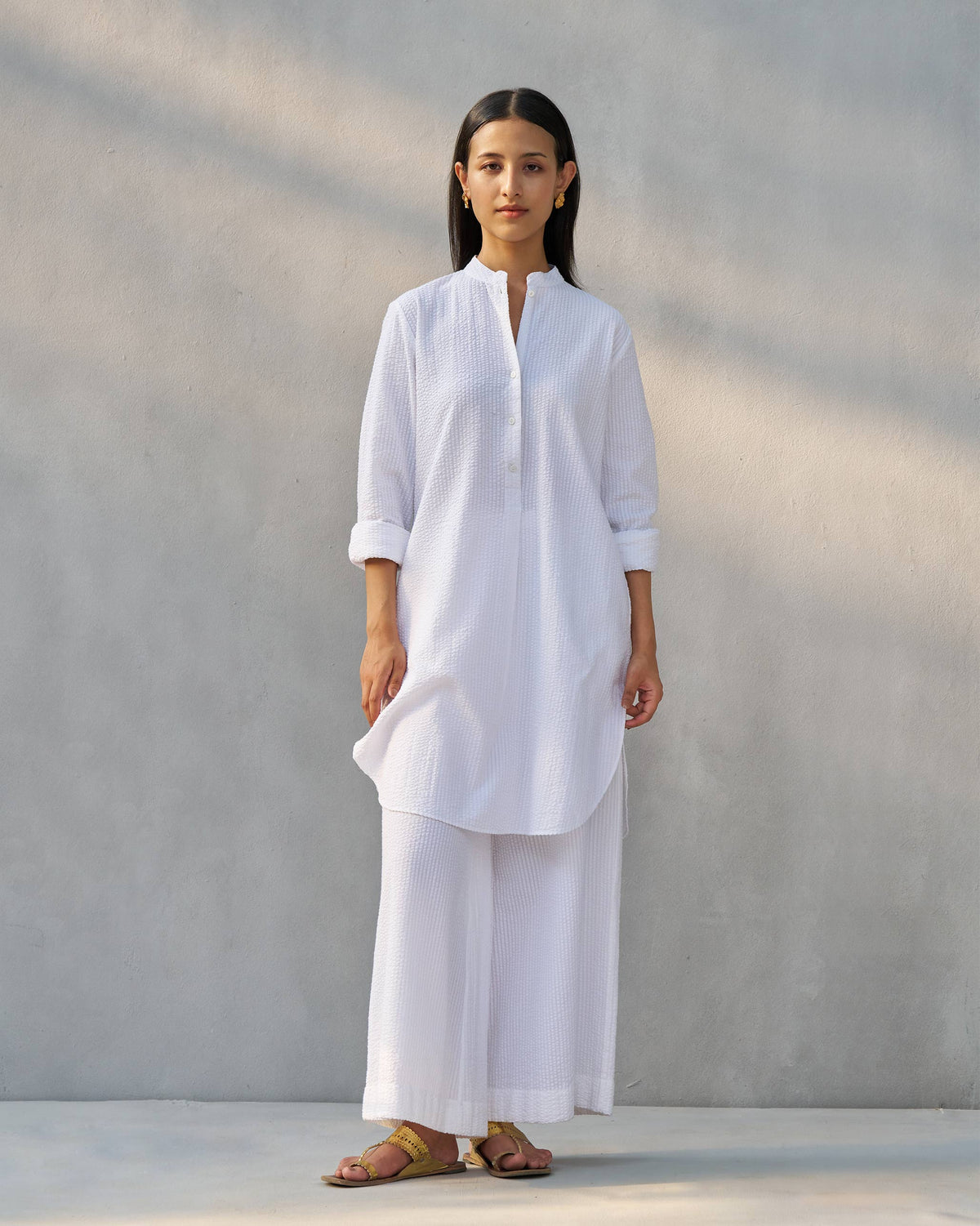 White seersucker Ice Set with a curved hem kurta and wide-leg pants.