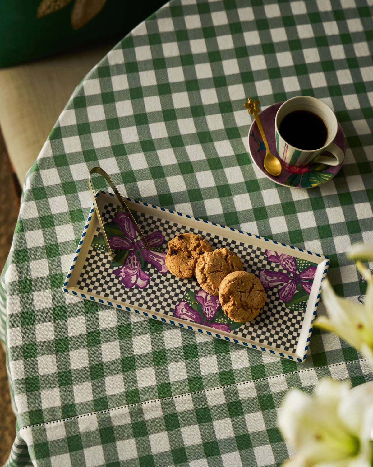 Buransh Cookie Tray with cookies and tongs beside a cup of coffee.