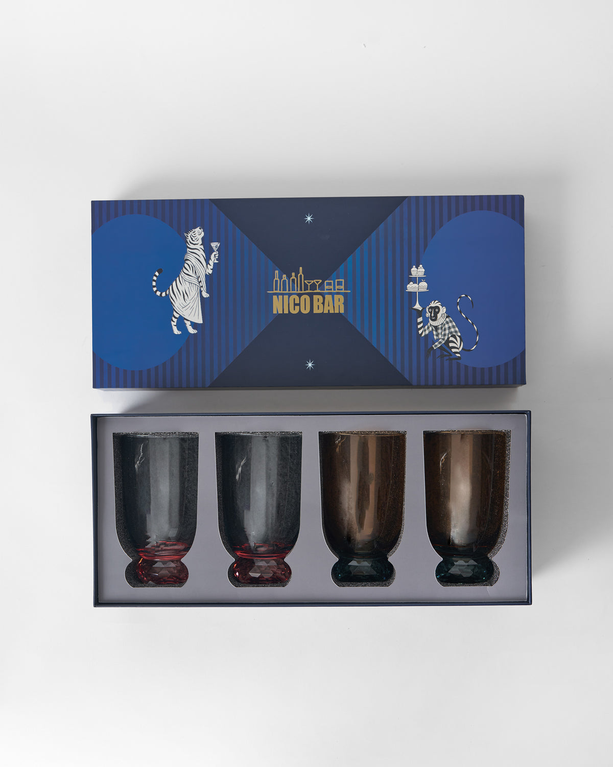 Open Nico Bar gift box holding four Reva sharbat glasses.