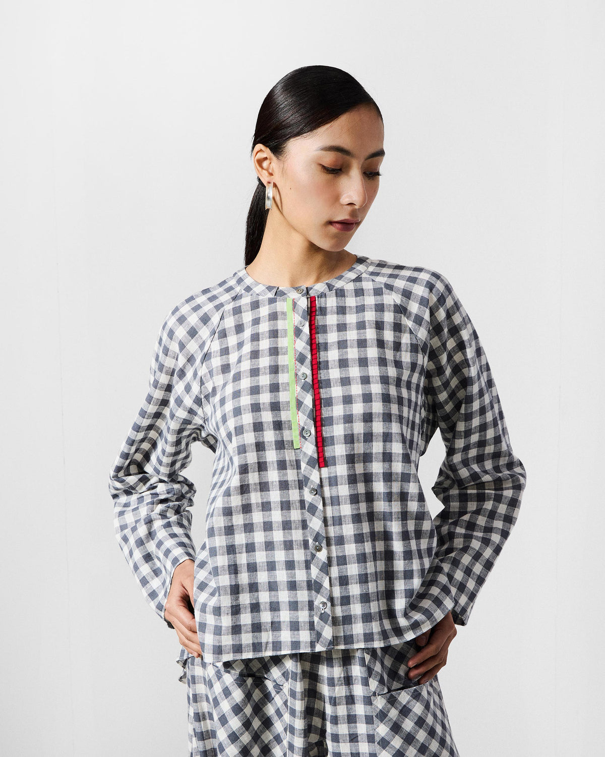 Person wearing a charcoal and white check Zil Top Set with contrasting trim.