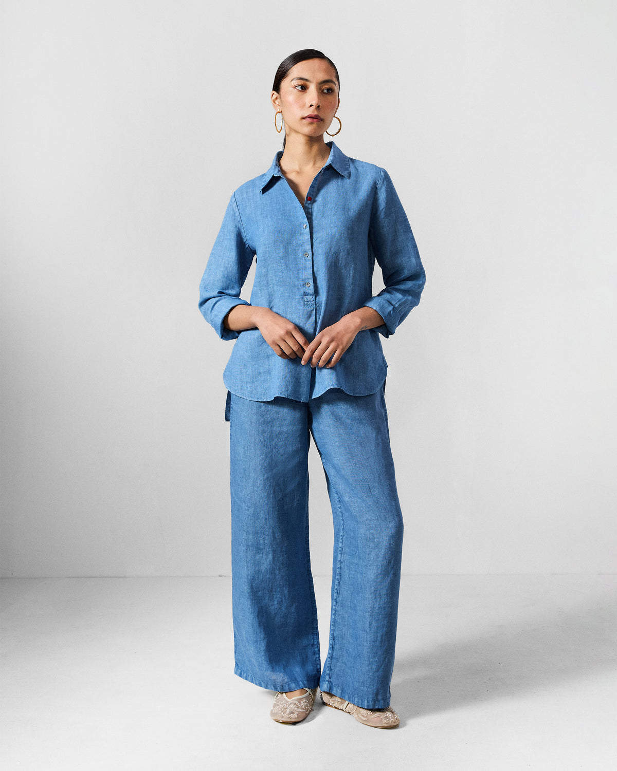 Person wearing a blue Mati shirt set with matching trousers.