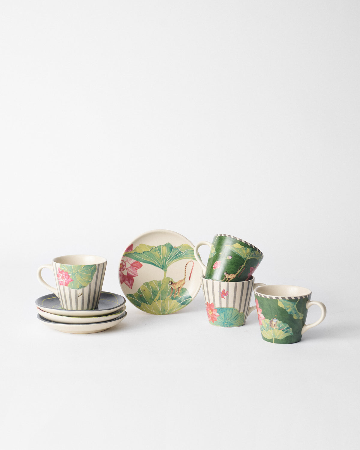 Mugs, saucers and a plate from the Floating Lotus set.