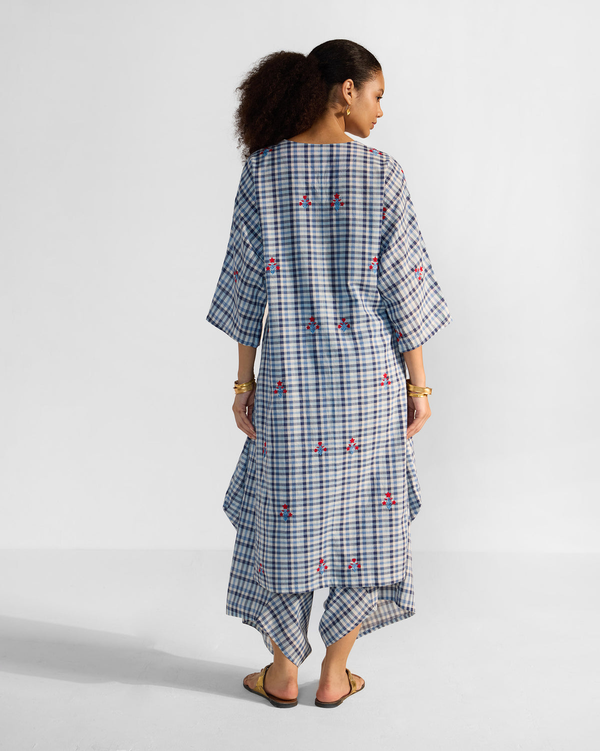 Back of a blue and white check Aava kurta with scattered red embroidery.
