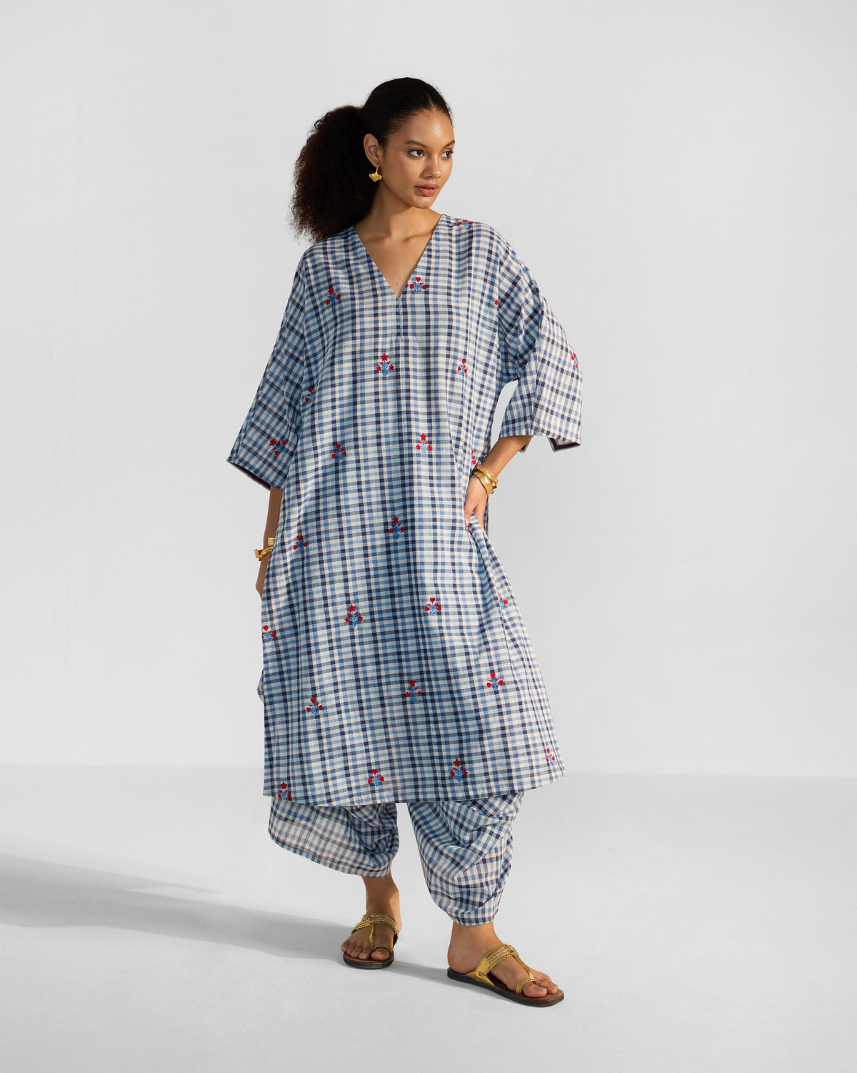 Blue and white check Aava kurta set showing side slits and matching draped pants.