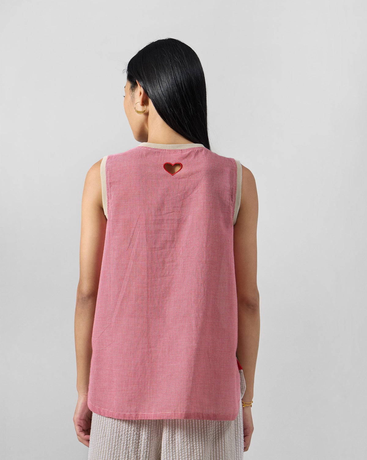 Back of a Tavira top with a red-trimmed heart cutout.