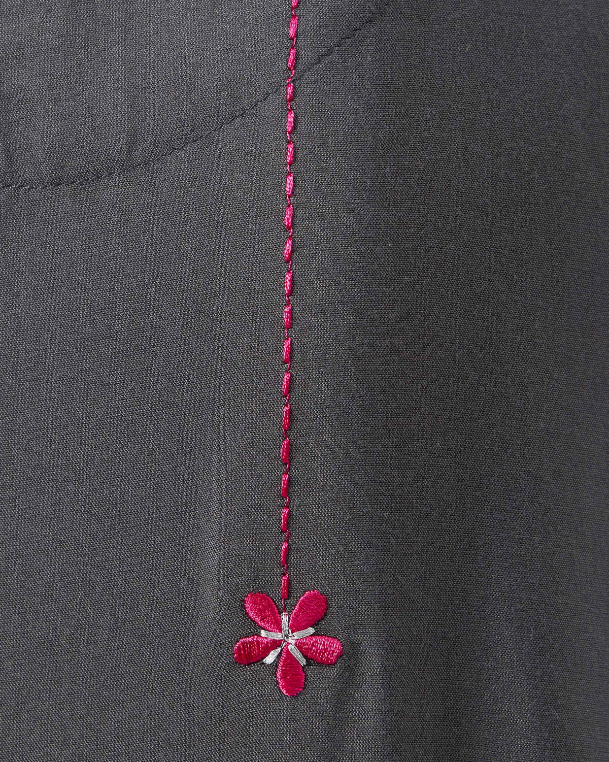 Close-up of a charcoal kurta set showing a magenta flower embroidery motif.