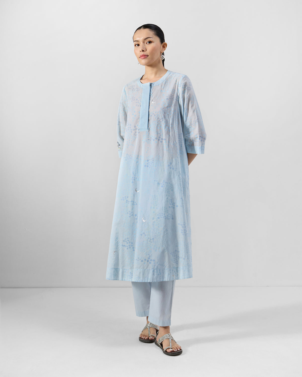 Person wearing a pale blue Kolva Kurta Set with tonal floral embroidery.