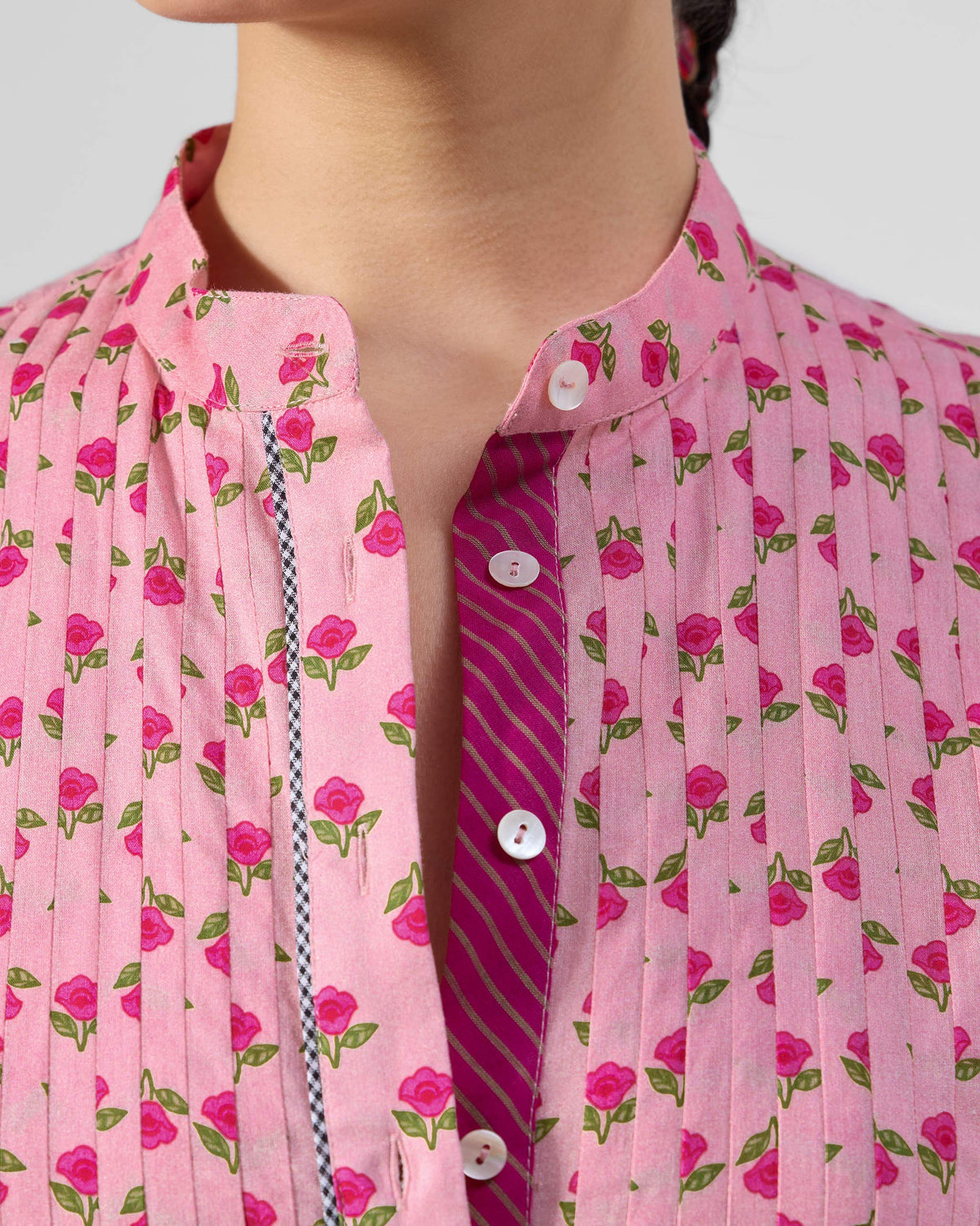 Close-up of the mandarin collar and pintucks on a pink Summer Fun kurta.