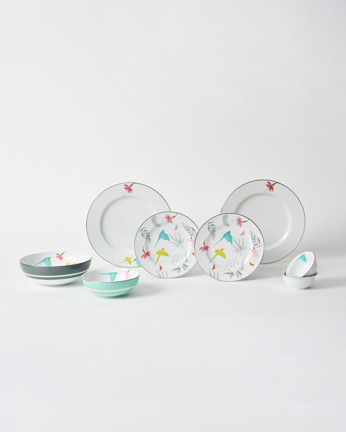Botanical Dinner set with plates and bowls laid out on white.