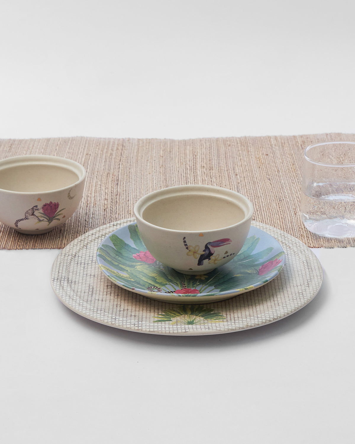 Madagascar place setting with toucan bowl on a tropical plate.
