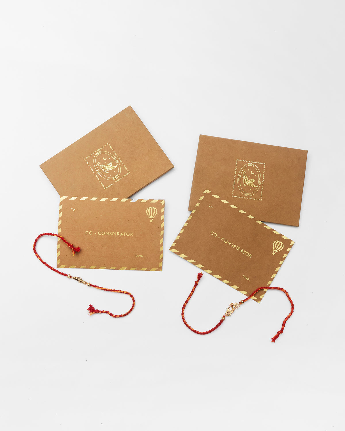 Vintage car rakhi set with gold charm rakhis on gift cards.