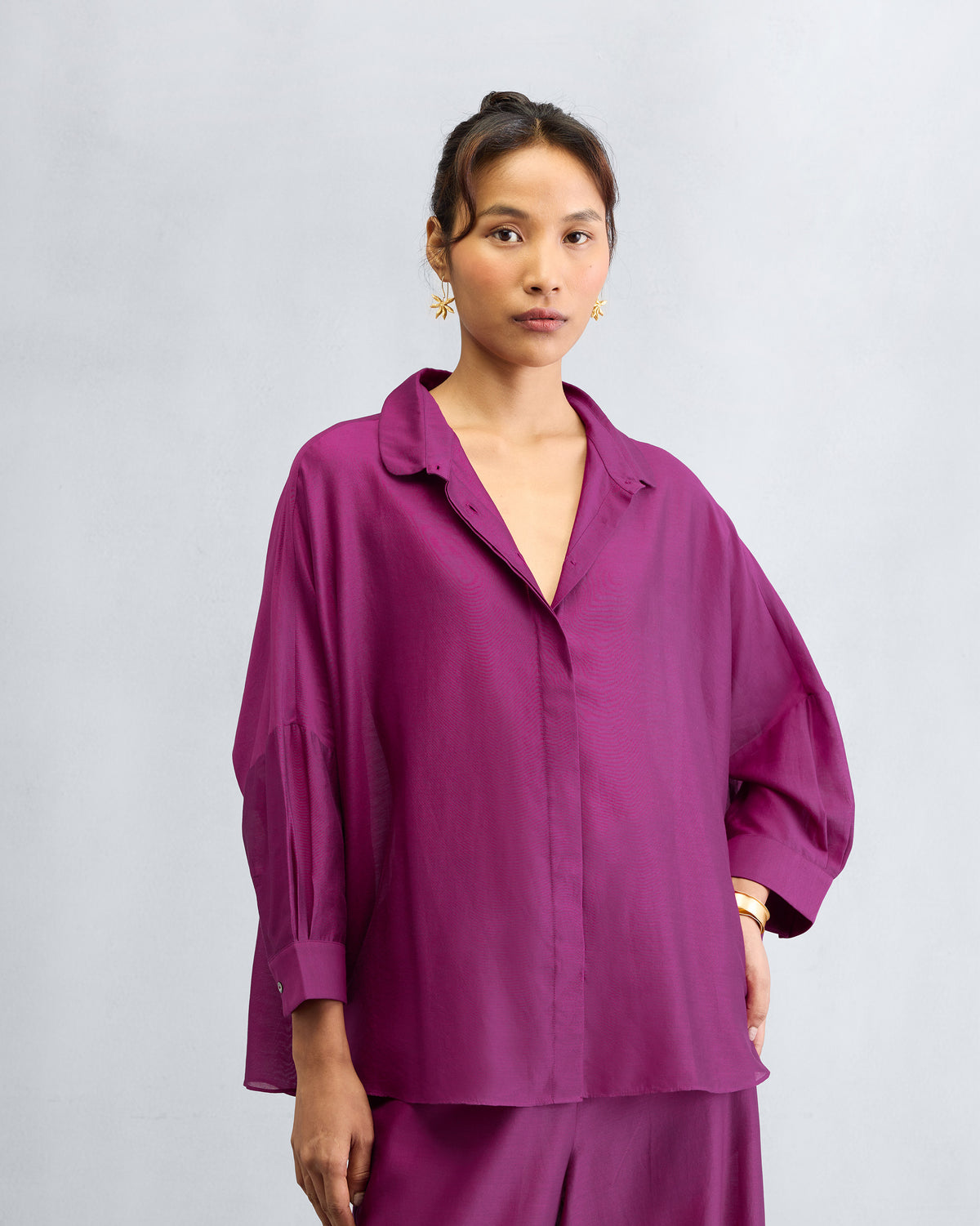 Mulberry boxy shirt with a relaxed collar and dropped shoulders worn by a person.