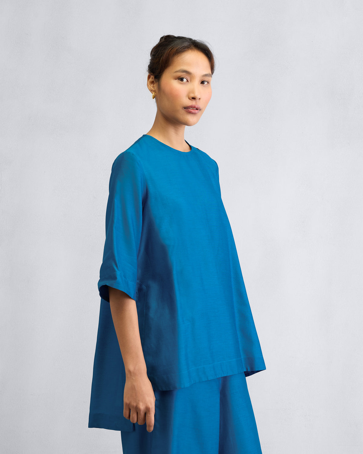 Side view of the High Slit Top Set worn by a person.