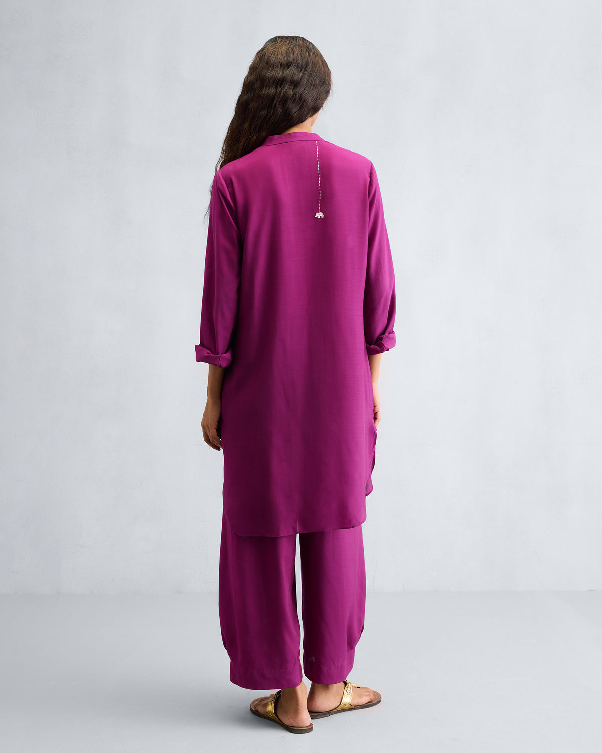 Back of a mulberry mid-length kurta set with a silver back detail.