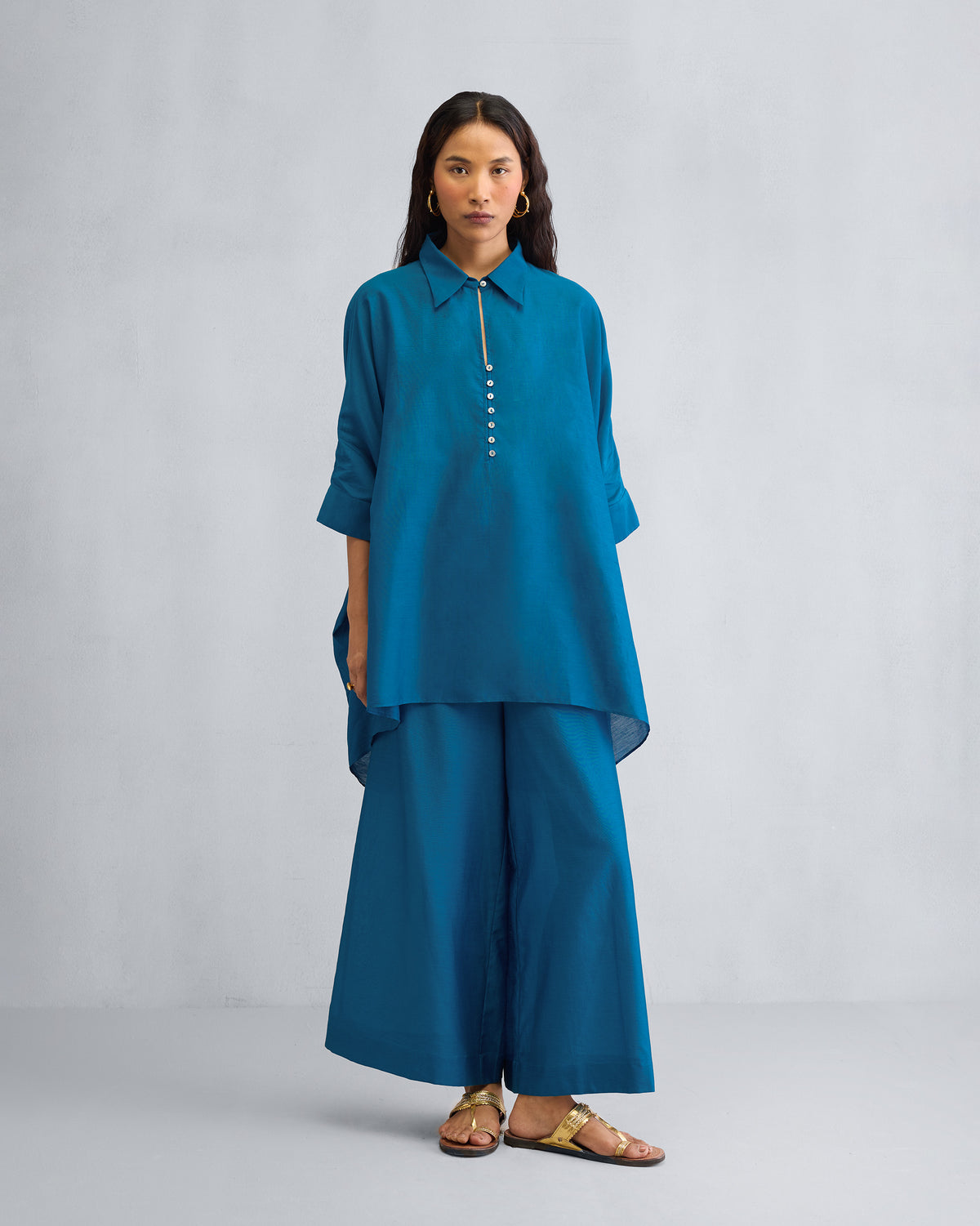 Person wearing the Hala Tunic Set in teal-blue.