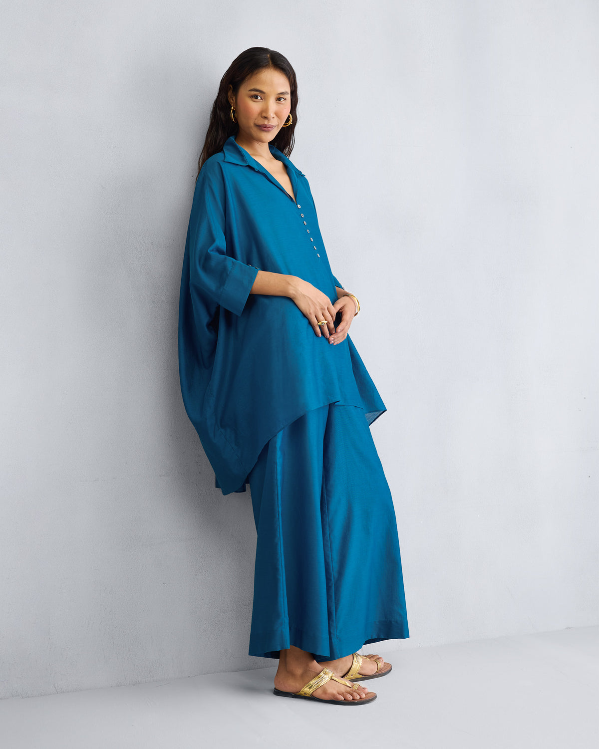 Person turned partly away, wearing the Hala Tunic Set.