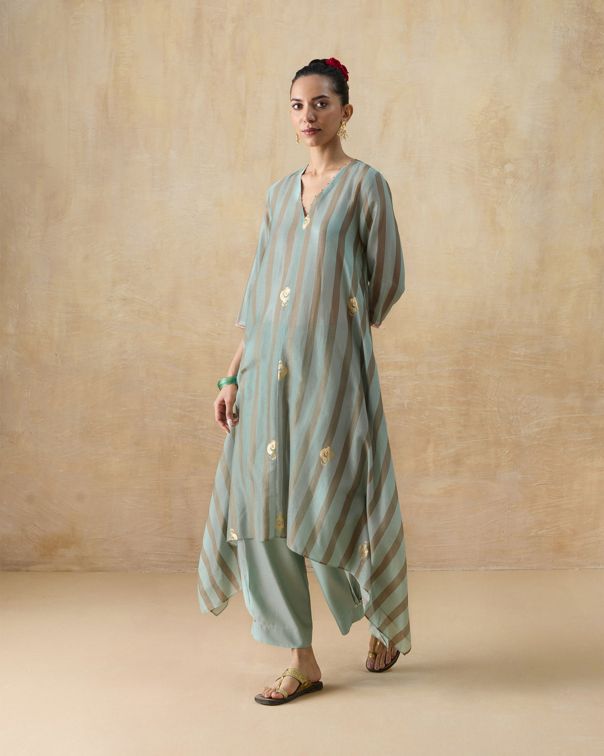 Green and tan striped Midnight Club kurta with gold motifs and matching pants.