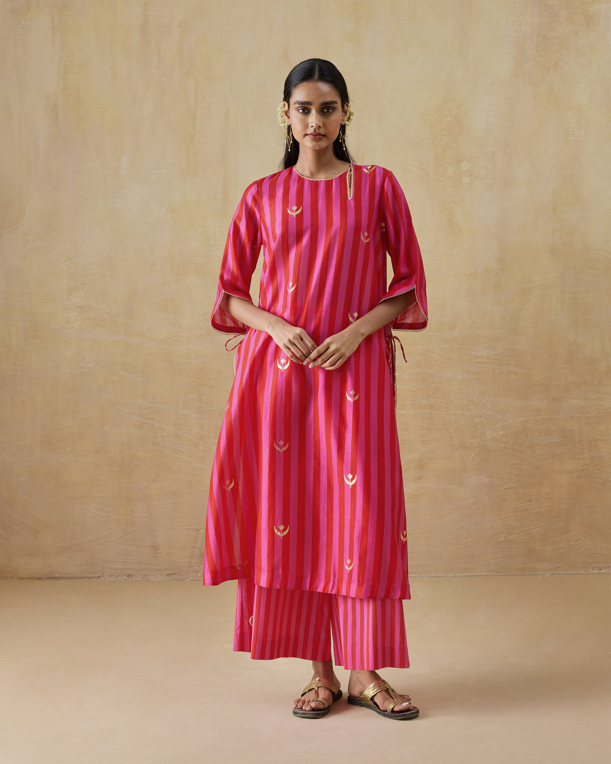 Person wearing a red and berry striped Galaxy kurta set with matching pyjamas.