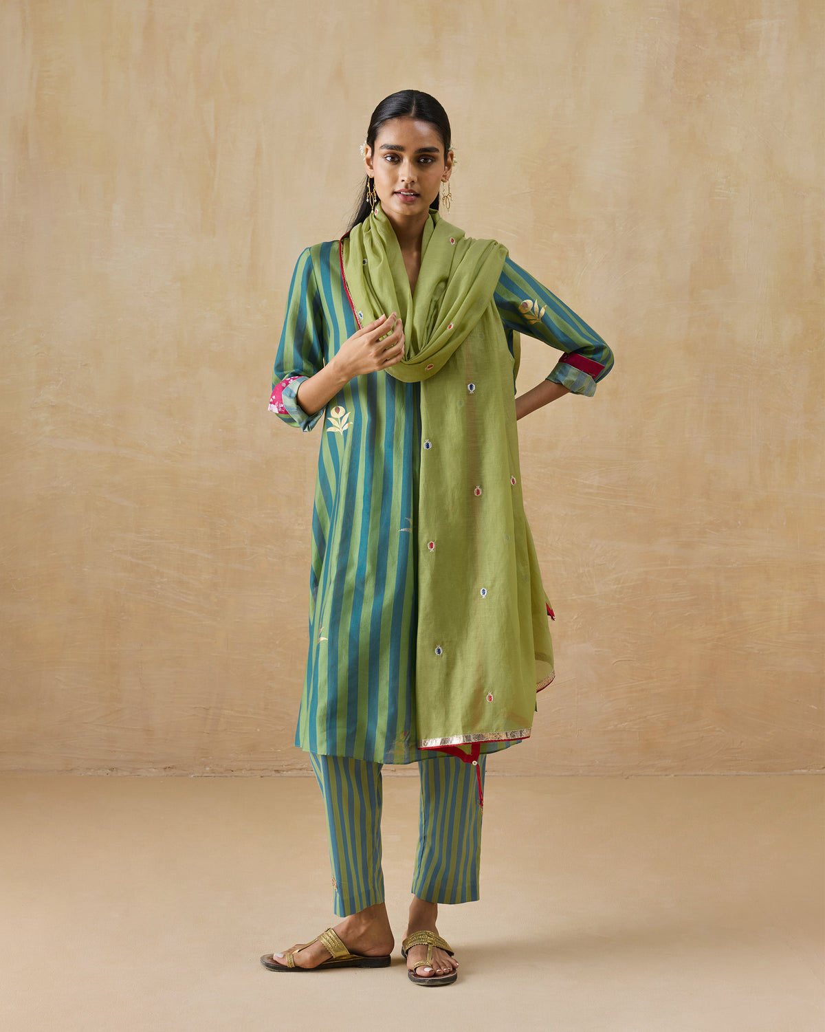 Person wearing a green striped Front Pleated Kurta Set with a draped green scarf.