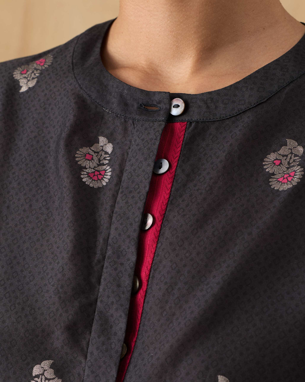Close-up of a fuchsia placket on a charcoal floral Lazy Sunday tunic.