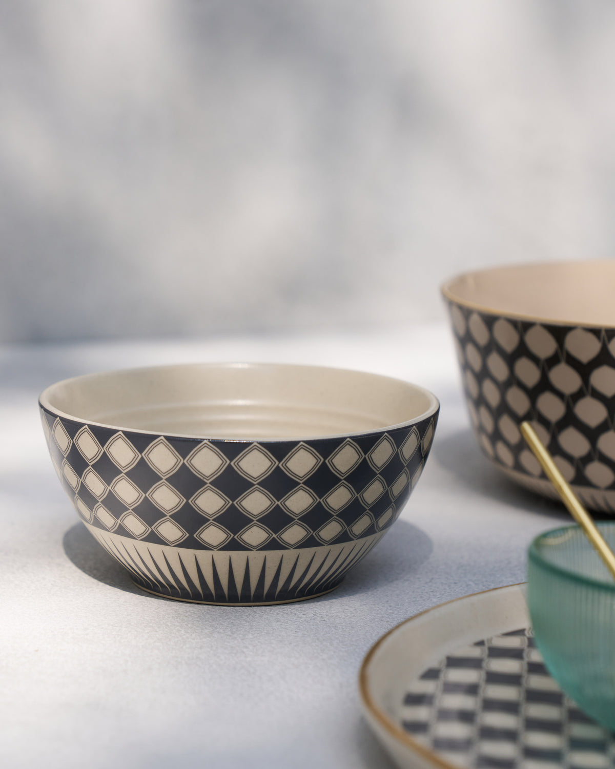 Fez cereal bowl with navy diamond pattern among matching tableware.