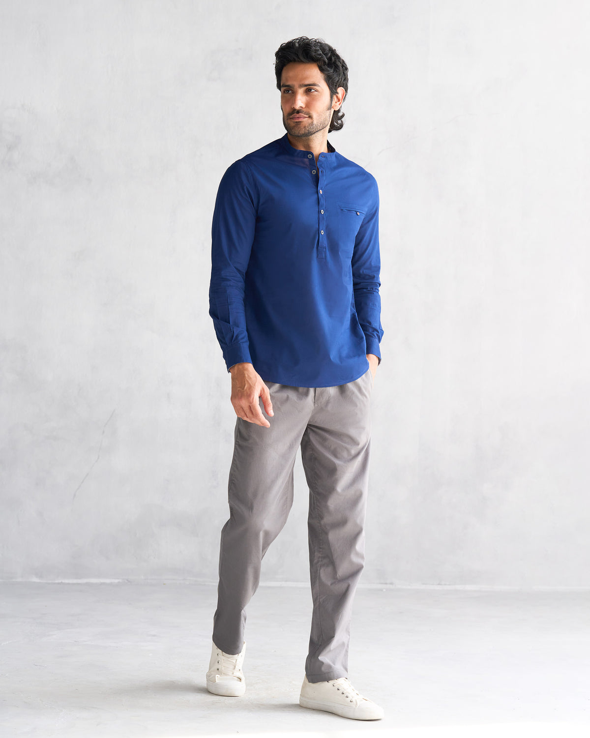 Full-length view of a blue Pondicherry shirt worn with grey trousers.