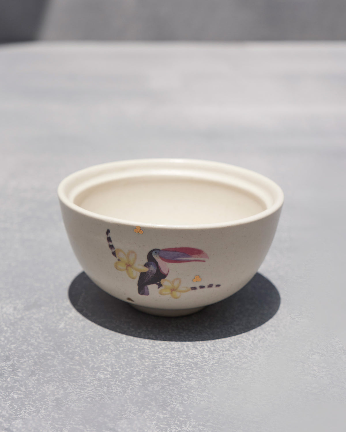 Cream Toucan katori angled to show the toucan motif and open interior.