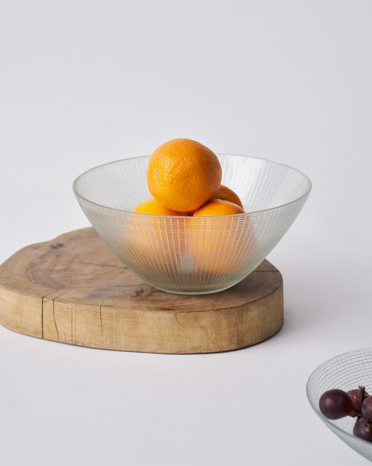Aire Serving Bowl holding oranges, shown in clear ridged glass.