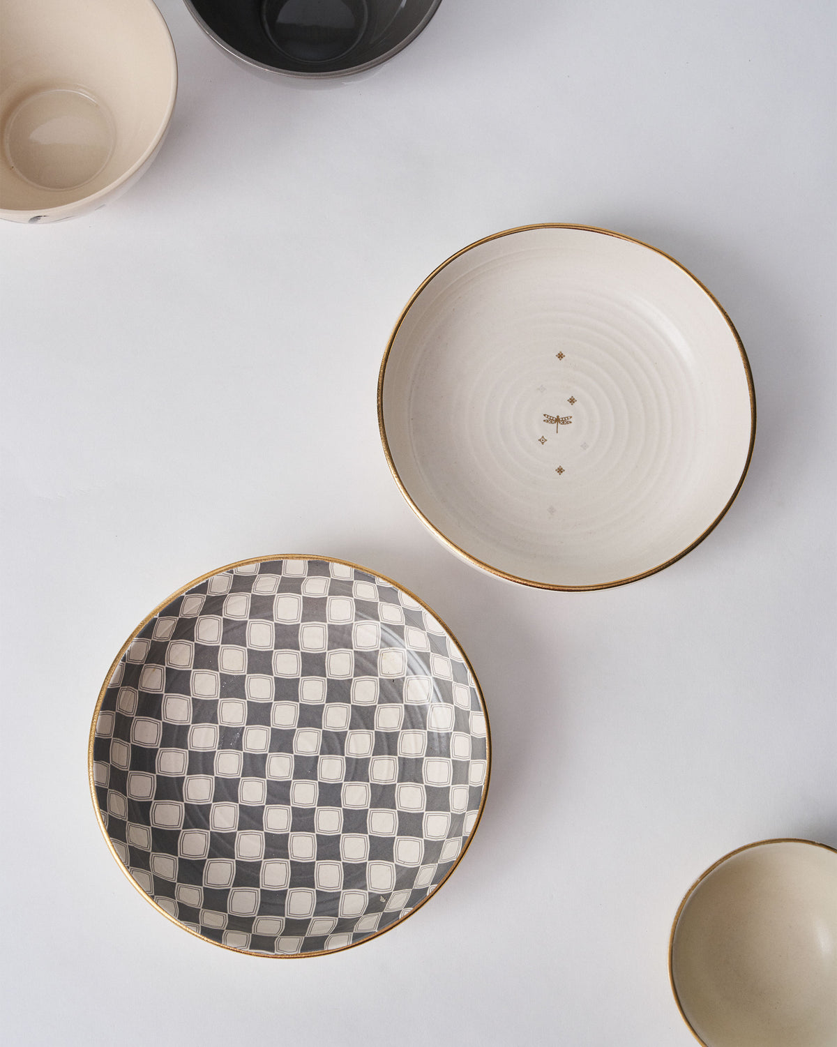 Fez Shallow Bowls with checkered and dragonfly designs among other bowls.