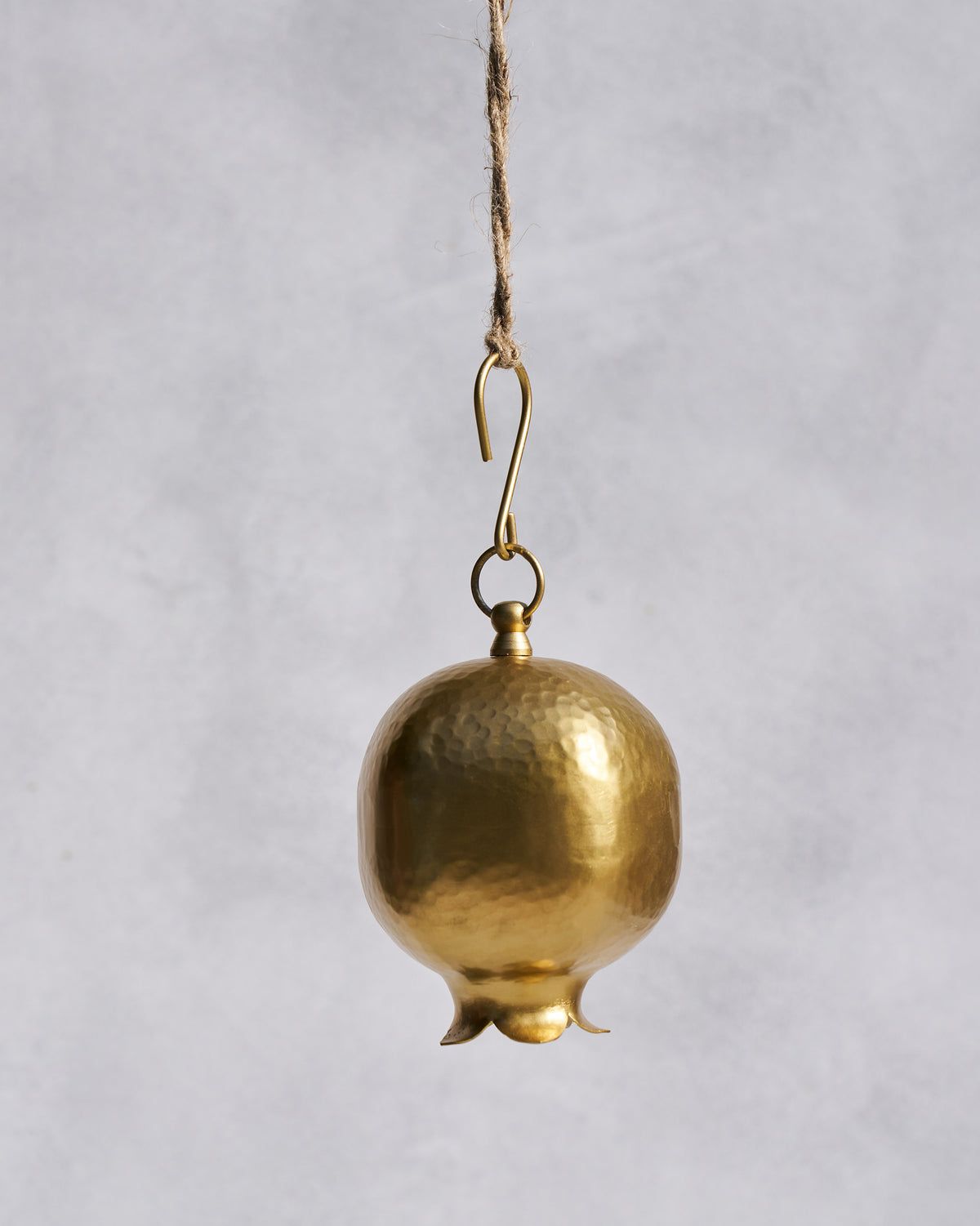 Hammered gold Anar bell shaped like a pomegranate on a hanging hook.