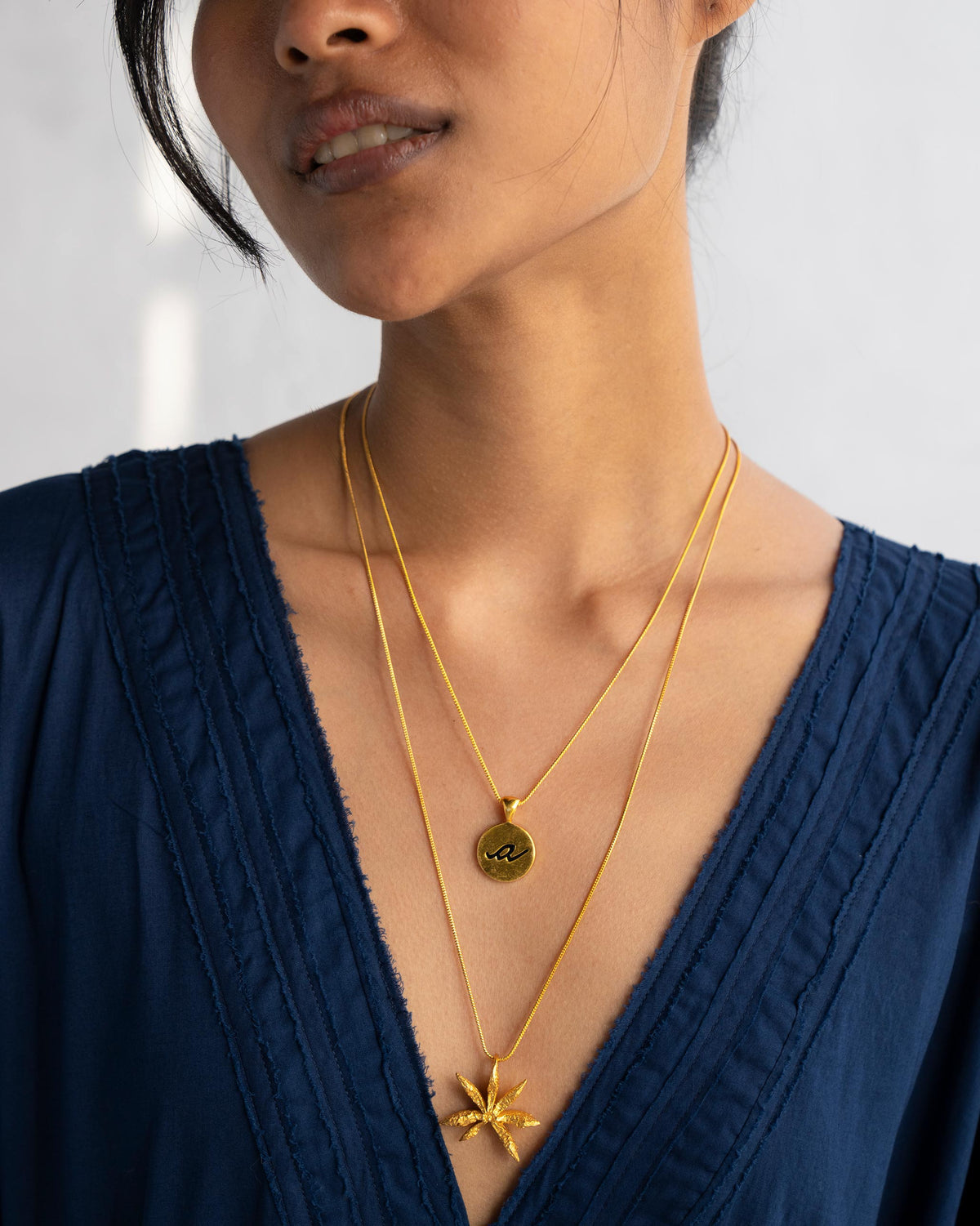 Alphabet A charm layered with a gold leaf pendant.
