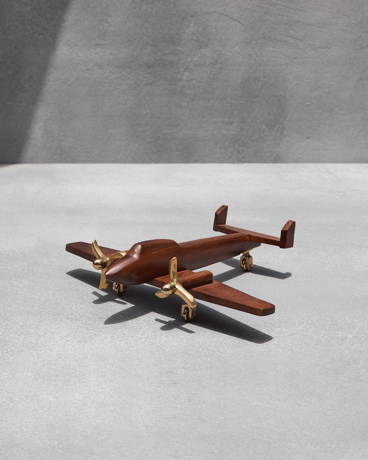 Small Beufort airplane model in wood with brass propellers.