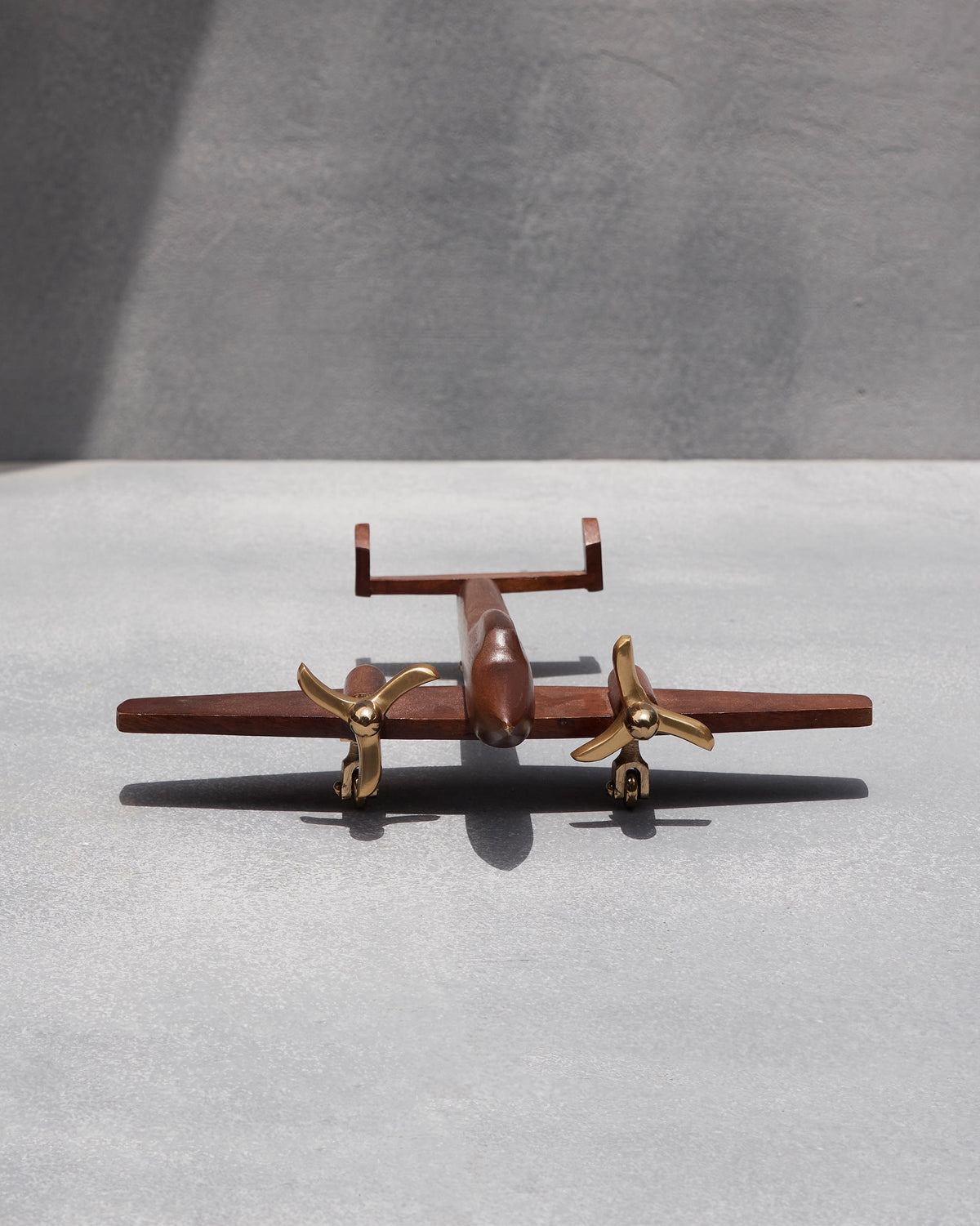 Beufort airplane seen head-on, with brass propellers and wooden wings.