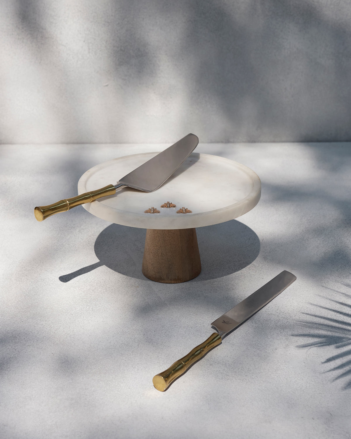 Sunrise cake knife and server with a marble cake stand.