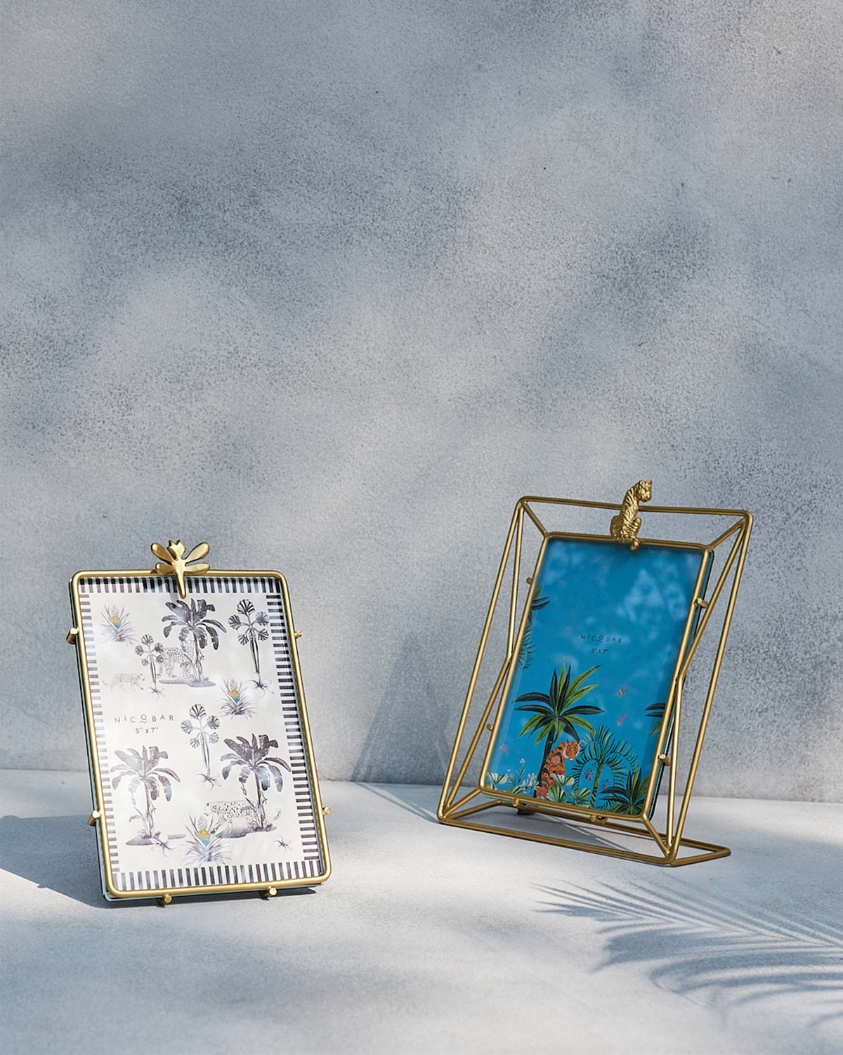 Gold woodland photo frame next to a second Nicobar frame.