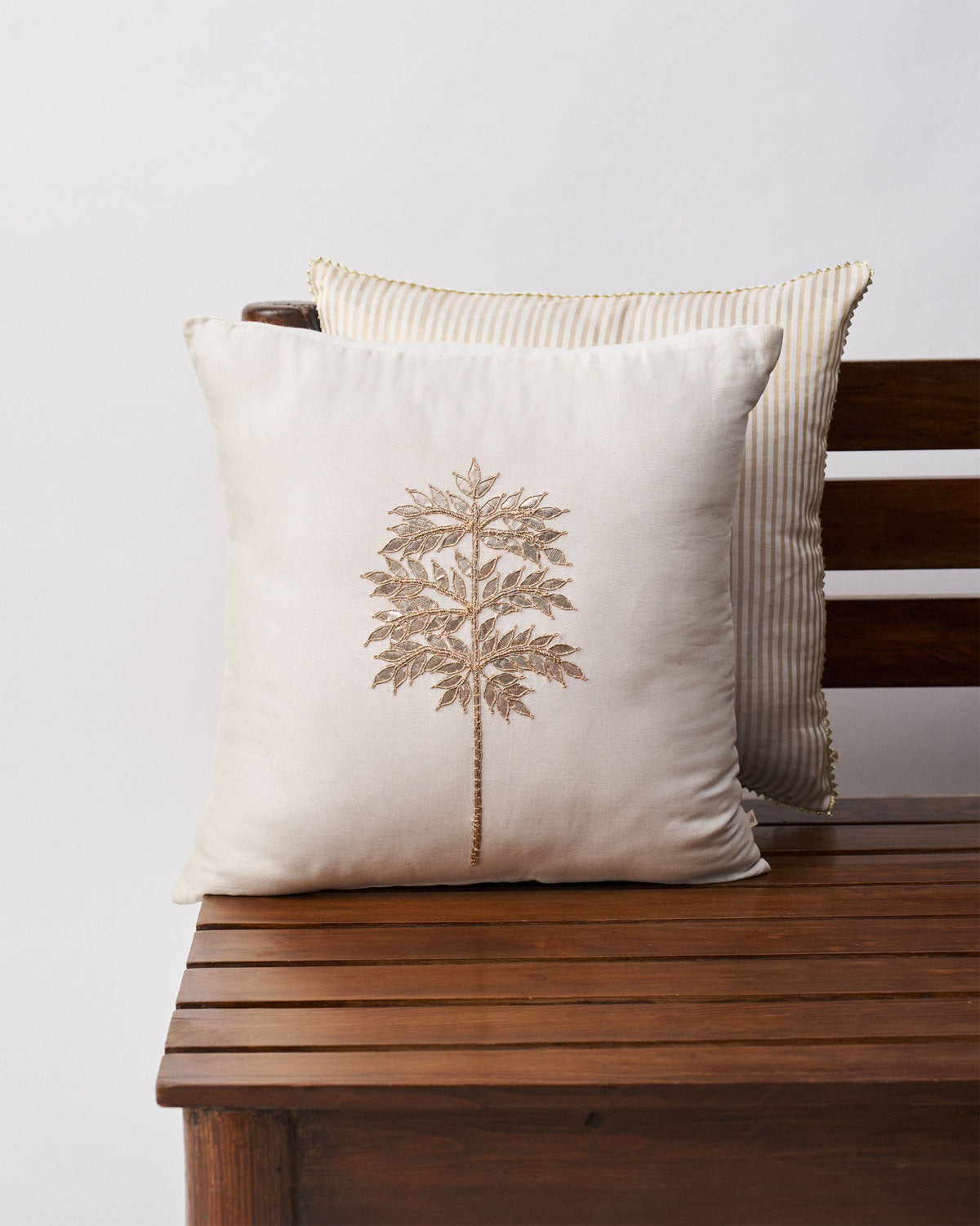Golden Palm Cushion Cover in cream with a gold embroidered palm motif.