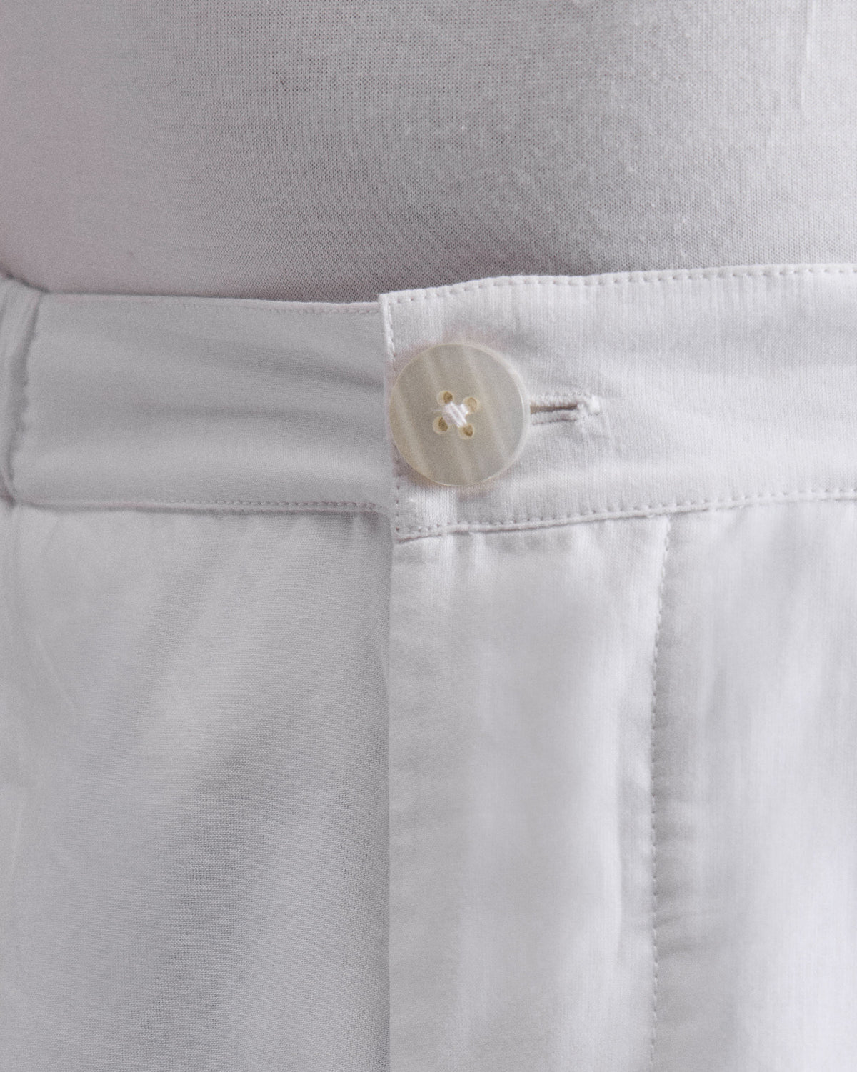 Close-up of white Shillong jammies showing the button waistband.
