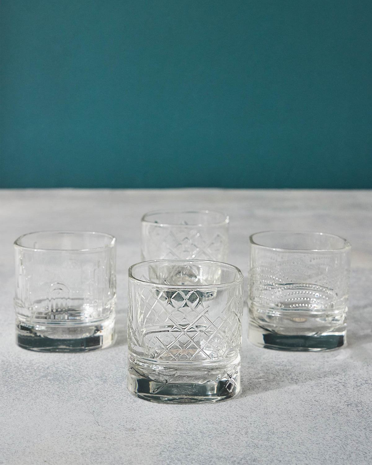 Four Mahi whiskey glasses with arch, lattice and dotted etches.