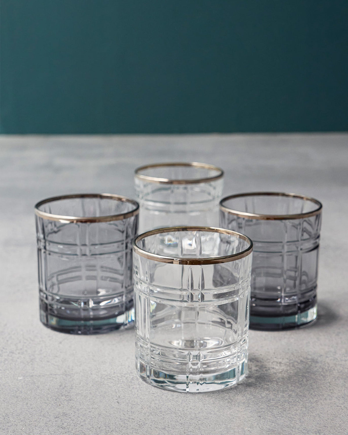 Clear and smoky Celeste whiskey glasses grouped to show the gold rims.