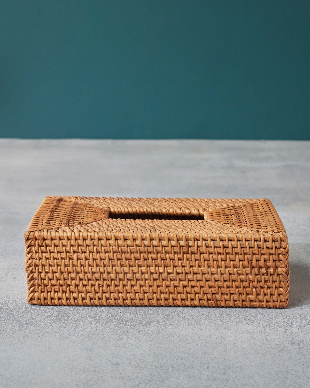 Natural rattan tissue cover with a basketweave pattern and open top slot.