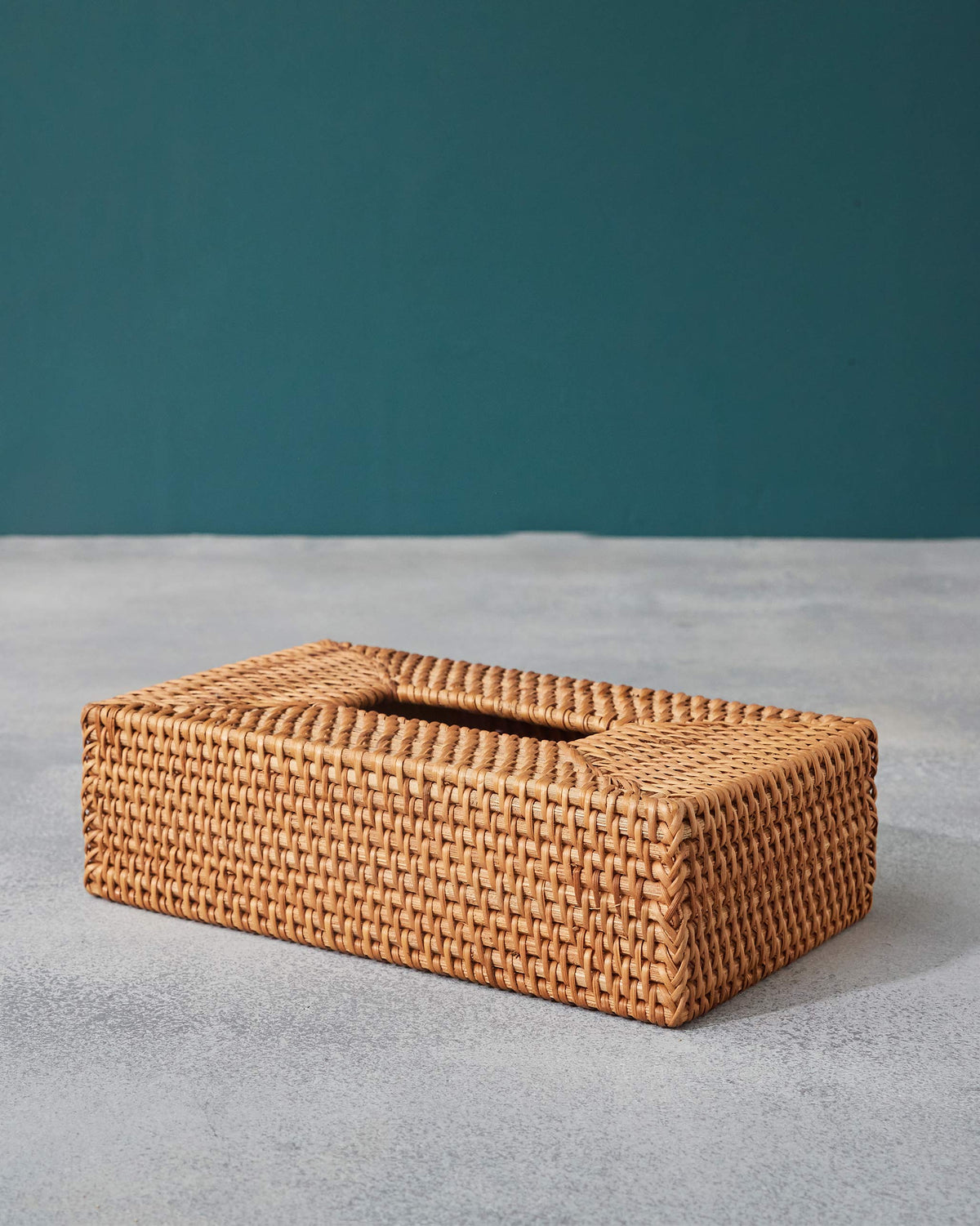 Honey rattan tissue cover showing woven sides and a braided edge.
