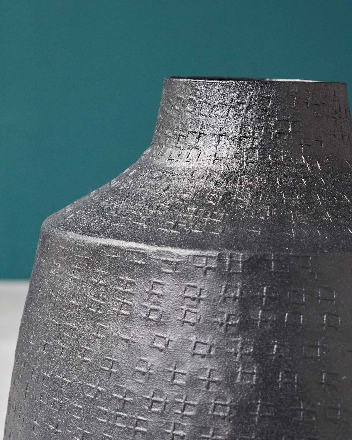 Close-up of Dhaara Vase showing its raised cross texture on the neck and shoulder.